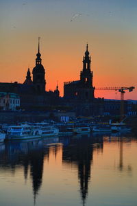 Reflection of building in river during sunset