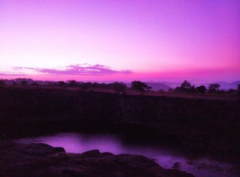 Scenic view of landscape against sky at sunset