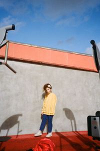 Woman standing against wall