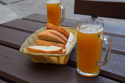 Beer glasses and breads on wooden table