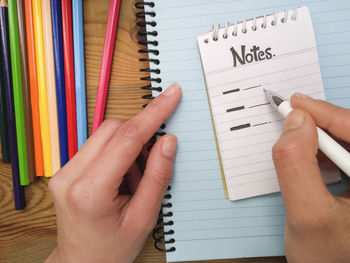 Cropped image of hand holding book