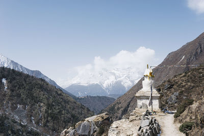Panoramic view of cross on mountain against sky