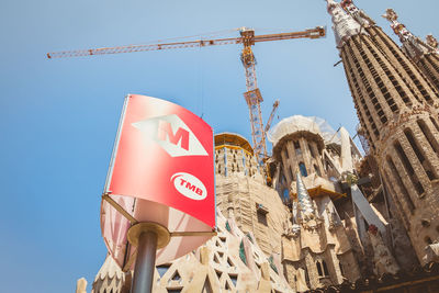 Low angle view of flags on building against sky