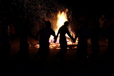 Silhouette people at night