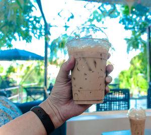 Close-up of hand holding drink