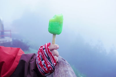 Close-up of hand holding ice cream cone