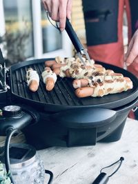 Close-up of person preparing food outside