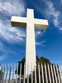 Low angle view of cross against sky