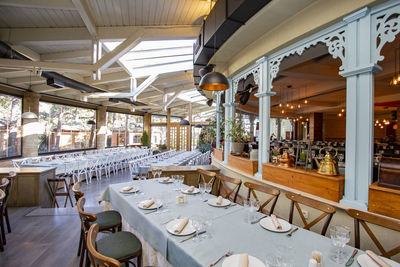 Empty chairs and tables in restaurant