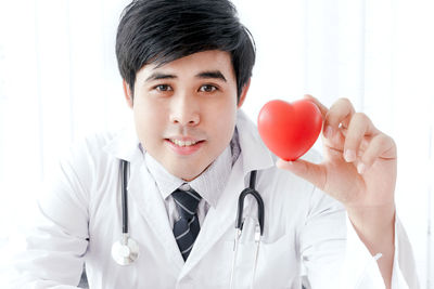 Portrait of doctor with stethoscope sitting in hospital