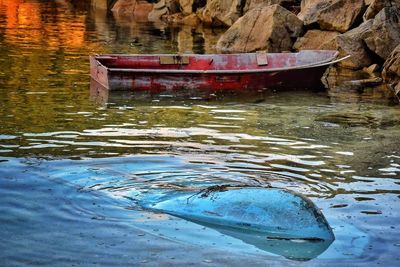 Close-up of boat moored in lake