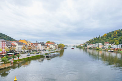 River amidst buildings in town against sky