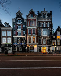 Street by buildings against sky