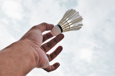 Midsection of person holding umbrella against sky