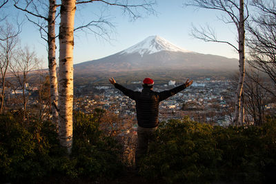 Man standing on landscape with mountain in background