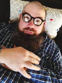 Portrait of man wearing eyeglasses at home