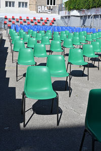 Empty chairs and tables in row