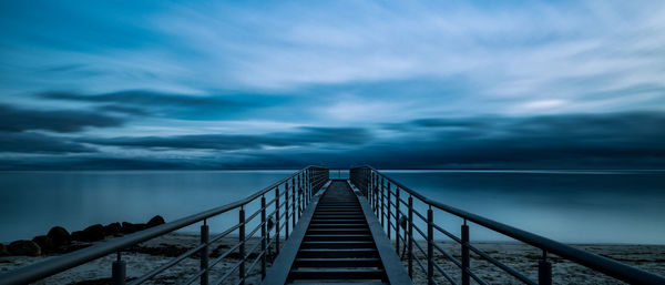 Pier over sea against sky