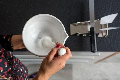 High angle view of hand holding mortar and pestle