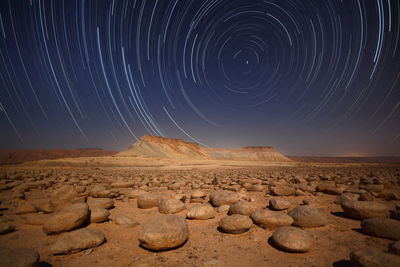 Scenic view of desert against sky at night