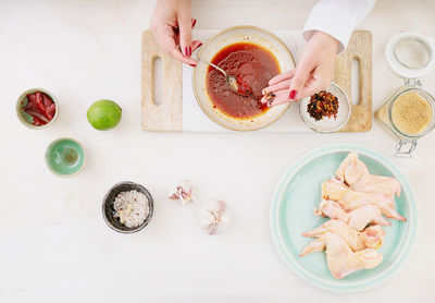 High angle view of woman holding food on table