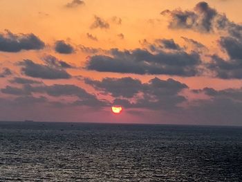 Scenic view of sea against romantic sky at sunset