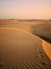 Scenic view of desert against sky during sunset