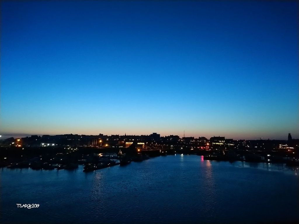 sky, water, copy space, city, building exterior, blue, no people, illuminated, architecture, clear sky, built structure, nature, waterfront, cityscape, night, dusk, scenics - nature, beauty in nature, river, outdoors