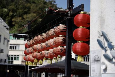 Low angle view of lanterns hanging by building in city