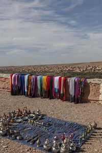 Clothes drying on beach against sky