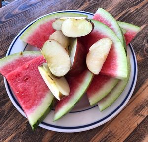 High angle view of chopped fruits in plate on table