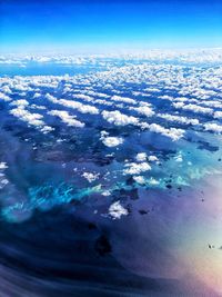 Aerial view of sea against blue sky