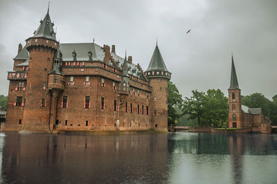 View of buildings at waterfront against sky