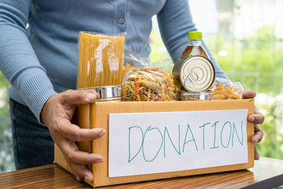 Midsection of man holding christmas presents