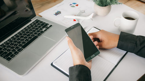 High angle view of man using laptop on table