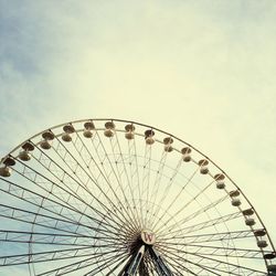 Low angle view of ferris wheel against sky