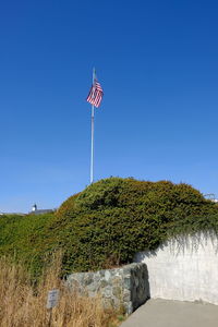 Scenic view of flag against clear blue sky