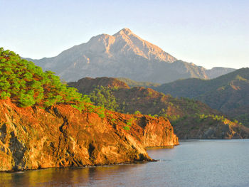 Scenic view of mountains and sea against sky