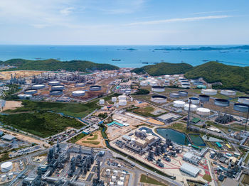 High angle view of buildings by sea against sky