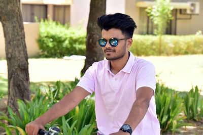 Young man wearing sunglasses standing outdoors