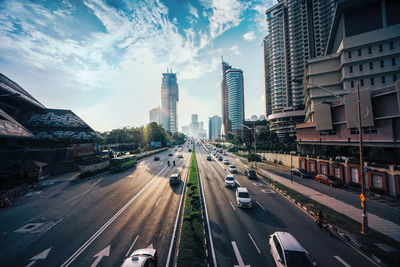 Panoramic view of city street and buildings against sky