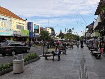 Cars on street against buildings in city