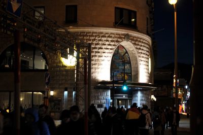 People in illuminated city at night