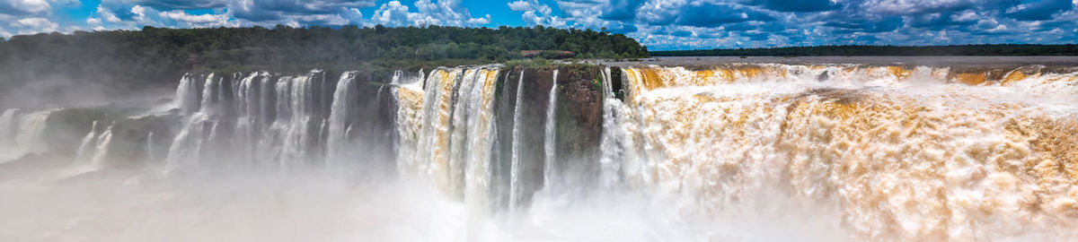 Scenic view of waterfall against sky