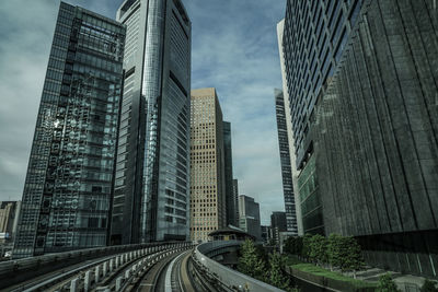 Modern buildings in city against sky