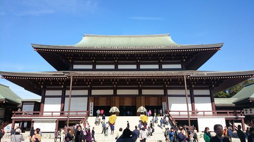 People at temple against sky