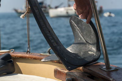 Rear view of man on boat at sea shore