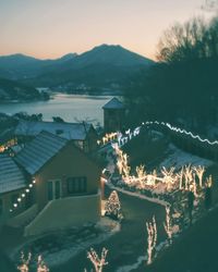 Scenic view of lake by mountains against sky during sunset