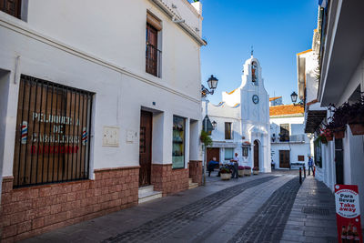 Street amidst buildings against sky