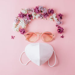 Close-up of pink flowers on sunglasses against white background